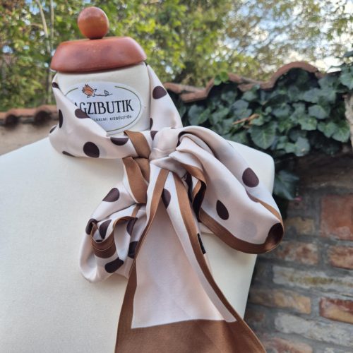 Keskeny, bézs-barna pöttyös kendő.