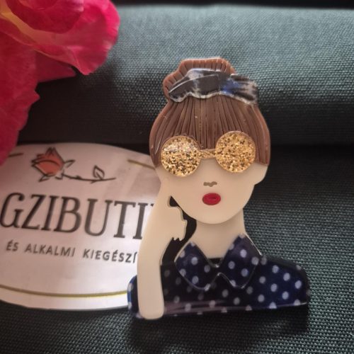 Női arc karakter kitűző barna hajjal.