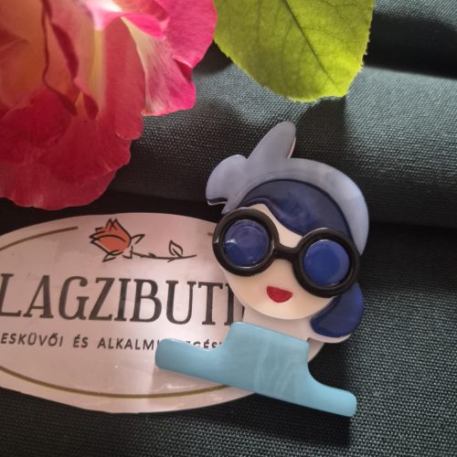 Női arc karakter kitűző, színes hajjal.